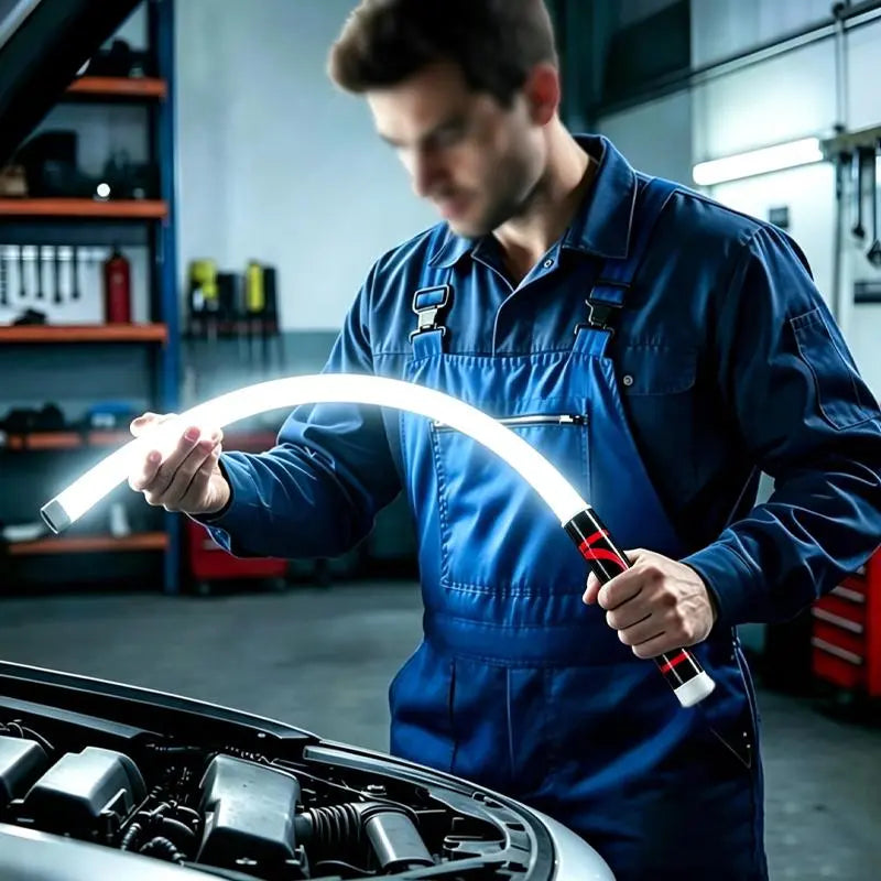 Mechanic holding a flexible illuminated LED repair light near an open engine bay